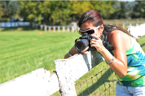 Amy Kwok taking photo along fence